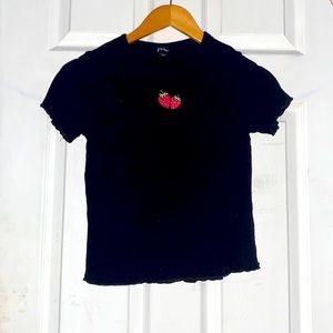 Black shirt with strawberry design on it